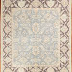 Peshawar rug with an all over design pale blue background and striking banded border.